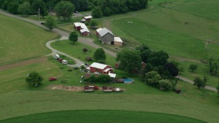 AX105_258 - 4.8K aerial stock footage orbiting a ranch house and a red barn, Pittsburgh, Pennsylvania