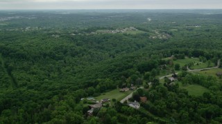 AX106_018 - 4.8K aerial stock footage of a forest near upscale neighborhood, Gibsonia, Pennsylvania