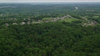 AX106_018E - 4.8K aerial stock footage of a forest near upscale neighborhood, Gibsonia, Pennsylvania