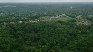 AX106_019 - 4.8K aerial stock footage of an upscale neighborhood near forest, Gibsonia, Pennsylvania