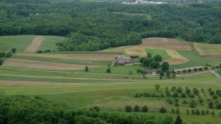 AX106_044 - 4.8K aerial stock footage of a farmhouse and farmland in Beaver Falls, Pennsylvania