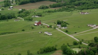 AX106_058 - 4.8K aerial stock footage flying over rural homes and a red barn in Enon Valley, Pennsylvania