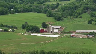 AX106_060 - 4.8K aerial stock footage of a red barn and silos in Enon Valley, Pennsylvania