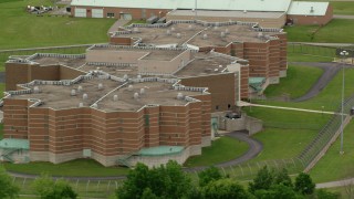 AX106_083 - 4.8K stock footage aerial video orbiting the front of Ohio State Penitentiary, Youngstown, Ohio