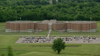 AX106_086 - 4.8K aerial stock footage orbiting the parking lot outside the Ohio State Penitentiary, Youngstown, Ohio