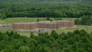 AX106_092 - 4.8K aerial stock footage orbiting Ohio State Penitentiary from a forest, Youngstown, Ohio