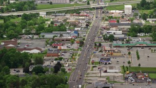 AX106_101E - 4.8K aerial stock footage of a city street, shops and strip mall in Youngstown, Ohio
