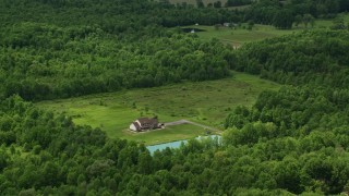 AX106_137 - 4.8K aerial stock footage of isolated home and pond in Newton Falls, Ohio