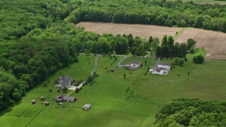 AX106_146 - 4.8K aerial stock footage orbiting rural homes in Garrettsville, Ohio