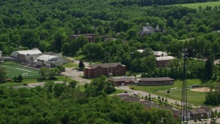 AX106_147E - 4.8K aerial stock footage of campus buildings and football field at Hiram College, Ohio