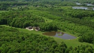 AX106_152E - 4.8K aerial stock footage of a waterfront home, reservoir and forest in Chagrin Falls, Ohio