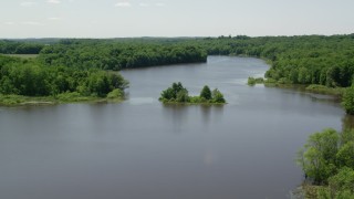 AX106_157 - 4.8K aerial stock footage of a tiny Island with trees in Akron City Reservoir, Chagrin Falls