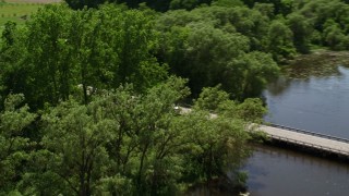 AX106_162 - 4.8K aerial stock footage flying over bridge and revealing rural homes by Akron City Reservoir, Chagrin Falls, Ohio