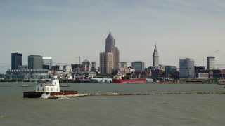AX106_210 - 4.8K stock footage aerial video of the skyline seen from a lighthouse, Downtown Cleveland, Ohio