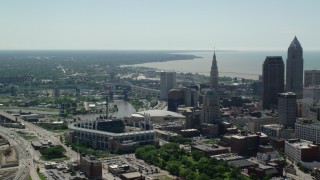 AX106_256 - 4.8K aerial stock footage of Progressive Field and skyscrapers in Downtown Cleveland, Ohio