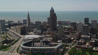 AX106_257E - 4.8K aerial stock footage fly over Progressive Field and between skyscrapers in Downtown Cleveland, Ohio