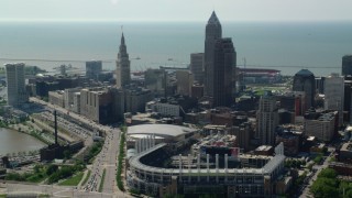AX107_028 - 4.8K aerial stock footage flying away from Progressive Field and Downtown Cleveland, Ohio