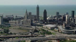 AX107_030 - 4.8K aerial stock footage of Downtown Cleveland skyscrapers and industrial buildings, Ohio