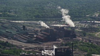 AX107_048 - 4.8K aerial stock footage of a factory with smoke stacks, Cleveland, Ohio
