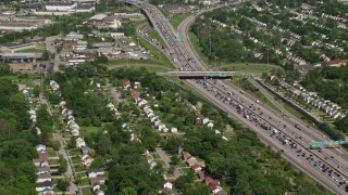 AX107_056E - 4.8K aerial stock footage of suburban homes and heavy traffic on Interstate, Cleveland, Ohio