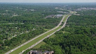 AX107_060E - 4.8K aerial stock footage of Interstate with light traffic bordered by trees, Cleveland, Ohio