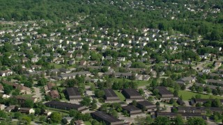 AX107_065 - 4.8K aerial stock footage of suburban homes among trees; Solon, Ohio
