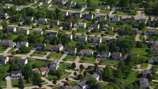 AX107_065E - 4.8K aerial stock footage of suburban homes among trees; Solon, Ohio
