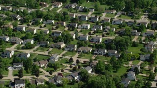 AX107_066 - 4.8K aerial stock footage flying by suburban homes, Solon, Ohio