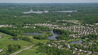 AX107_067E - 4.8K aerial stock footage approaching a lakeside suburban neighborhood, Aurora, Ohio