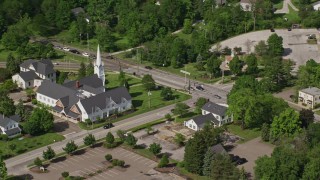 AX107_075 - 4.8K aerial stock footage flying by a church along a busy road, Aurora, Ohio