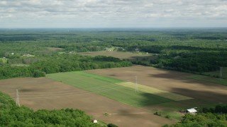 AX107_088 - 4.8K aerial stock footage of farmland and trees, Ravenna, Ohio