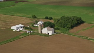 AX107_096E - 4.8K aerial stock footage of a farmhouse and barns, Newton Falls, Ohio