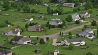 AX107_109E - 4.8K aerial stock footage of approaching rural homes, New Waterford, Ohio