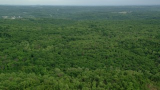 AX107_118 - 4.8K aerial stock footage flying over forests, Darlington, Pennsylvania