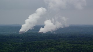 AX107_124 - 4.8K aerial stock footage of steam rising from a power station's cooling towers, Beaver Valley Power Station, Pennsylvania