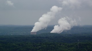 AX107_125 - 4.8K aerial stock footage of steam from a power station's cooling towers, Beaver Valley Power Station, Pennsylvania