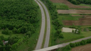 AX107_129 - 4.8K aerial stock footage of an interstate running along forests and farmland, Beaver Falls, Pennsylvania