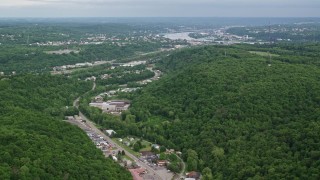 AX107_130 - 4.8K aerial stock footage of forests and industrial buildings, Beaver Falls, Pennsylvania