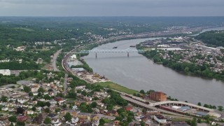 AX107_135 - 4.8K aerial stock footage of a bridge spanning a river along a town, Monaca, Ohio River, Pennsylvania