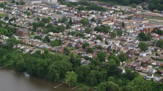 AX107_136 - 4.8K aerial stock footage of a suburban community near the river, Ohio River, Monaca, Pennsylvania