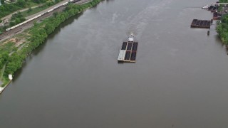 AX107_137 - 4.8K aerial stock footage approaching a barge on the river, Ohio River, Monaca, Pennsylvania
