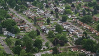 AX107_138E - 4.8K aerial stock footage orbiting a residential neighborhood, Monaca, Pennsylvania