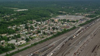 AX107_140 - 4.8K aerial stock footage of homes near a rail yard, Conway, Pennsylvania
