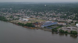 AX107_155E - 4.8K aerial stock footage of warehouses by the river, Coraopolis, Pennsylvania