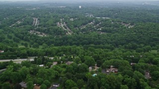 AX107_205 - 4.8K aerial stock footage of suburban neighborhoods and forests, Penn Hills, Pennsylvania