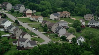 AX107_213 - 4.8K aerial stock footage flying by a residential neighborhood, Penn Hills, Pennsylvania