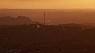AX108_002 - 4K aerial stock footage flying by a radio tower, Penn Hills, Pennsylvania, sunset
