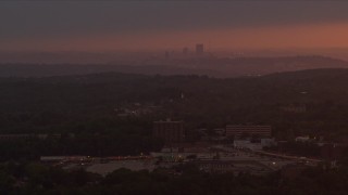 AX108_003 - 4K aerial stock footage flying by apartment buildings, Penn Hills, Downtown Pittsburgh, sunset