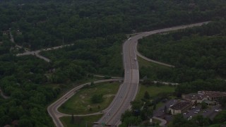 AX108_005 - 4K aerial stock footage following an interstate through trees, Pittsburgh, Pennsylvania