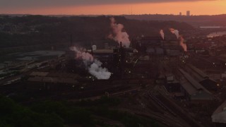AX108_015 - 4K aerial stock footage of the U.S. Steel Mon Valley Works, Braddock, Pennsylvania, sunset